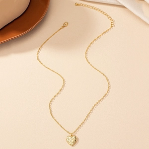 Elegant gold heart pendant necklace with woven texture on a minimalist O-chain necklace