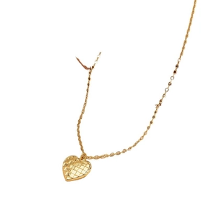 Minimalist gold heart pendant necklace with textured grid pattern on white background