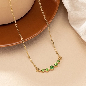 French vintage gold necklace with five graduated green gemstones on a fine cable chain