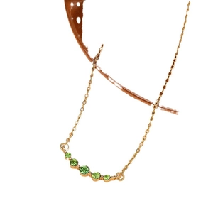 French vintage style gold necklace featuring five graduated green emerald zircon stones