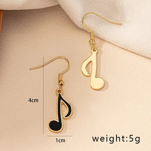 Detail shot of musical note earrings showing 4cm length and 1cm width dimensions