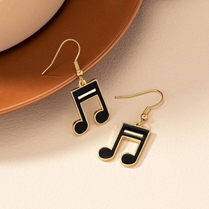 Minimalist black and gold musical note drop earrings with elegant enamel finish