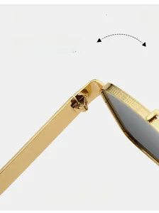 Detailed macro view of durable golden metal hinge and engraved wavy patterns on sunglasses