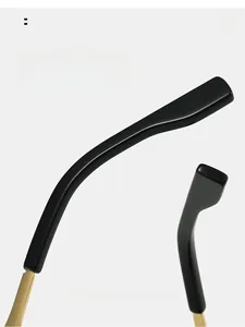 Detail of ergonomic curved sunglasses arms with gold metal accents and polished finish