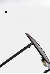 Détail de lunettes œil-de-chat en métal avec liseré rouge et charnières de branche robustes