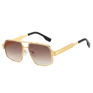 Luxury gold pilot sunglasses with brown gradient lenses and engraved metal frames