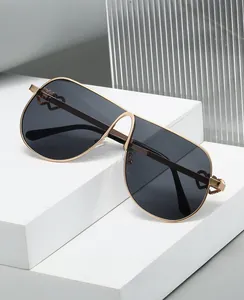 Detail of metal frame sunglasses featuring a hollow heart accent on the side temple