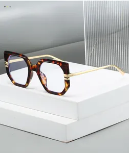 Detail of tortoiseshell geometric eyeglass frames with elegant gold metal temples