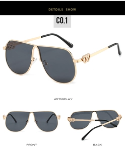 Detail of pilot sunglasses with hollow double heart design on gold metal frames