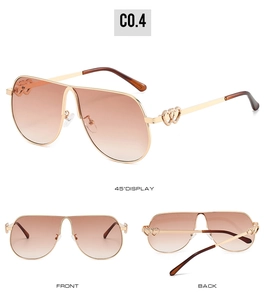 Detail of pilot sunglasses with gold metal frame and heart-shaped hollow temple decor