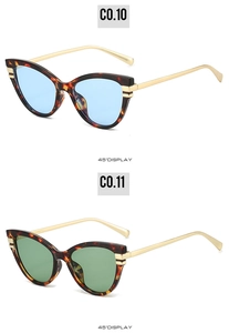 Detail of tortoise shell cat eye sunglasses with gold temples and colorful lenses