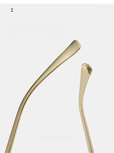 Close-up of curved golden metal temples with ergonomic arc design for glasses