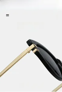 Detail of high-quality hinge joining black cat-eye frame and gold metal temples