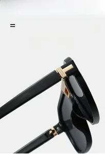 Detailed close-up of golden T-shaped hinge on vintage double bridge aviator sunglasses
