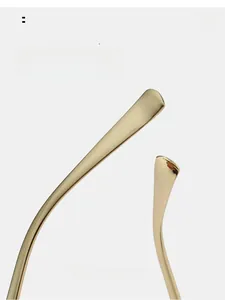 Detailed macro view of curved golden metal sunglasses legs for enhanced wearing comfort
