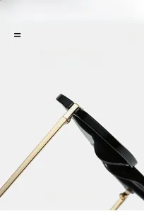 Detail of premium black acetate frame with golden metal hinges on aviator sunglasses