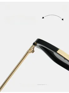 Close-up of durable golden metal hinge and screws on black square aviator sunglasses