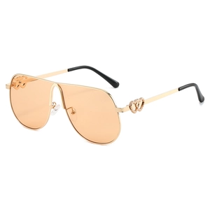 Oversize aviator sunglasses with gold frame and amber lenses on a white background