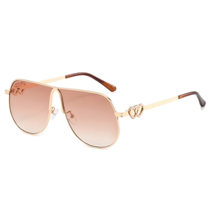 Oversized gold metal pilot sunglasses with gradient lenses and heart temple details