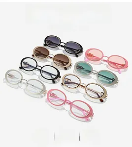 Detail view of oval retro sunglasses featuring unique hollow heart hinges on the temples