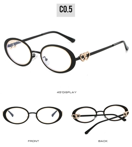 Detail view showing black oval frames with golden double heart hinges from three angles