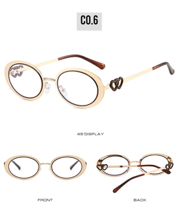 Detail of oval glasses with gold metal frames and hollow heart-shaped temple design