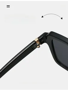 Detail of durable gold metal hinge on square black sunglasses with smooth finish