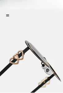 Detail of lightweight sunglasses temples with interlocking gold hearts and matte finish