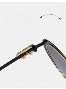 Detail shot of durable reinforced gold hinges on stylish oval frame black sunglasses