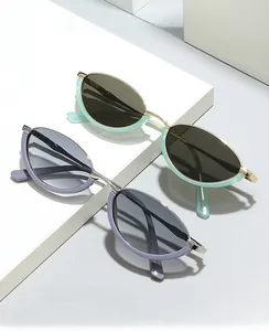Detail of mint green and purple cat eye metal frames with transparent temples