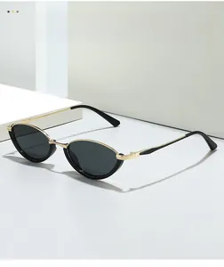 Detailed view of cat-eye sunglasses with black frame and golden metal nose bridge