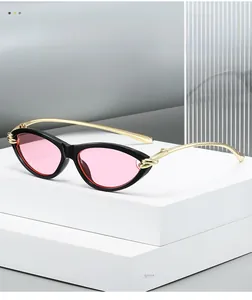 Detail of cat eye sunglasses featuring gold metal temples and twisted knot hinge design