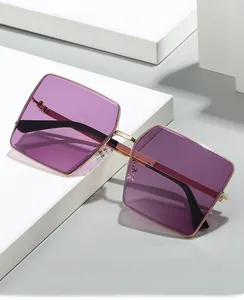 Detail of purple gradient lens and gold metal frame on rimless square sunglasses