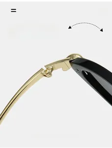 Macro view of durable gold-toned metal hinge and polished black frame on cat eye sunglasses