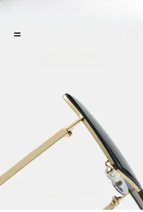 Detail of rimless square sunglasses showing metal hinge structure and lens edge craft