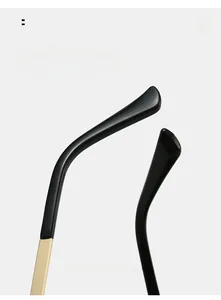Detail of curved black and gold sunglasses legs showing ergonomic comfort design