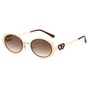 Oval gold metal sunglasses with dual-heart hollow design and brown gradient lenses