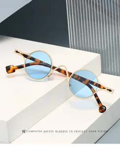 Detail of vintage round metal sunglasses with blue lenses on white geometric stairs