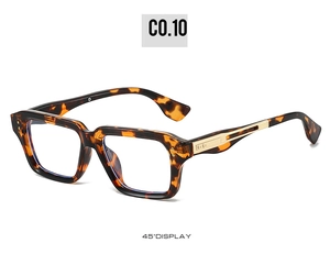 Detail of square tortoiseshell frame with golden metal accents and striped temple pattern