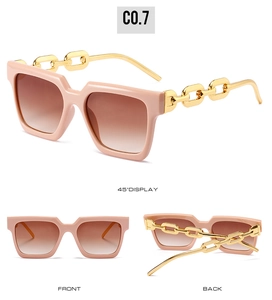Pink square sunglasses with thick gold chain temples and brown gradient lenses