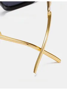 Macro view of gold metal curved temples on fashion sunglasses for comfortable wear