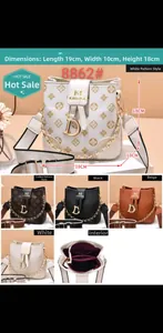 Detailed view of bucket bag interior compartments and chain strap with metal D-charm