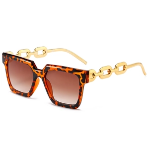 Fashionable oversized square tortoiseshell sunglasses with bold gold chain temples