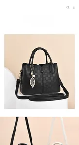 Detail of black plaid embossed PU leather tote with leaf pendant and pearl charm