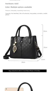 Detail of black textured tote bag showing main compartment and gold leaf charm