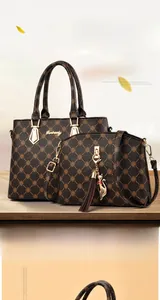 Detail showing printed faux leather tote and crossbody bag set with gold hardware