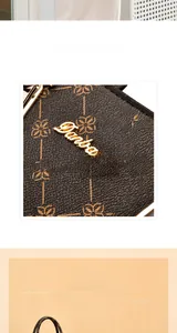 Detailed close-up of brown printed leather texture and gold Danbaoly brand plaque