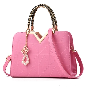 Pink V-shaped embossed tote bag with woven handles and pearl charm pendant