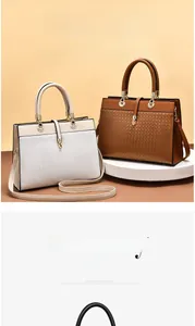 Detail of woven texture and gold hardware on beige and brown leather tote bags