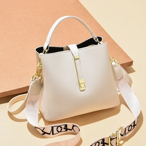 Chic cream bucket bag with lychee texture and stylish wide printed shoulder strap